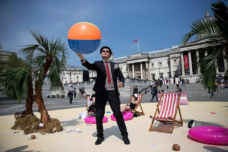 A demonstrator dressed as a businessman protesting against tax avoidance at a "tropical tax haven" near the global anti-corruption summit venue. Critics said the proposed public registers of company ownership might not make a meaningful impact unless