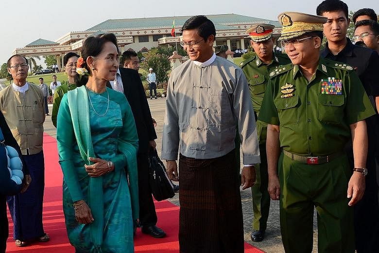 Ms Suu Kyi at the Naypyitaw city airport last Friday with military chief Senior General Min Aung Hlaing (right). He said the army reported important matters, when necessary, to Ms Suu Kyi.