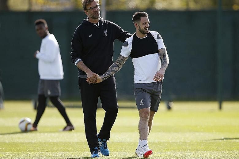 Liverpool manager Juergen Klopp with Danny Ings during a training session. The German aims to turn the Reds into one of the Premier League's fittest teams through tough pre-season training.