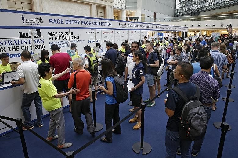 Readers who signed up for the May 22 The Straits Times Run in the City queueing to collect their race entry packs at Raffles City Atrium (Level 3) yesterday. Participants can still collect their packs today and tomorrow (10.30am to 8pm) at the same v