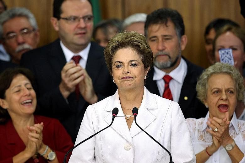 Mrs Rousseff (left) used her final minutes in the presidency to denounce the "coup" and urge supporters to mobilise as she braced herself for an impeachment trial. Mr Temer (above) wasted no time in putting his stamp on Brazil.
