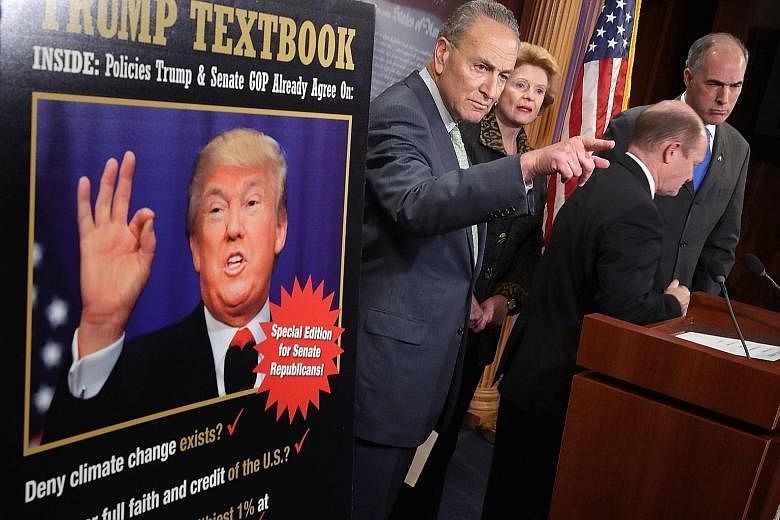 Democratic senators ( from left) Charles Schumer, Debbie Stabenow, Chris Coons and Robert Casey holding a news conference on Thursday following meetings between Mr Trump and Republican leaders. They pointed to policies that Mr Trump and Republicans a