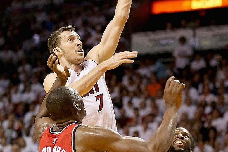 Miami Heat guard Goran Dragic scores two of his 30 points to help his team beat the Toronto Raptors 103-91 and level the Eastern Conference Semi-final series at 3-3.