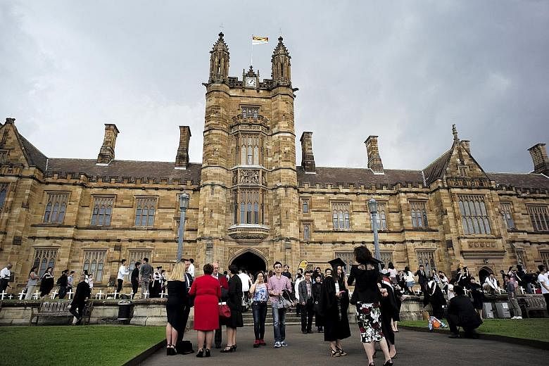 Students and their family members on the campus of the University of Sydney after a graduation ceremony. Australian government figures show that the number of Singaporeans enrolled in law, postgraduate medicine and allied health has grown.