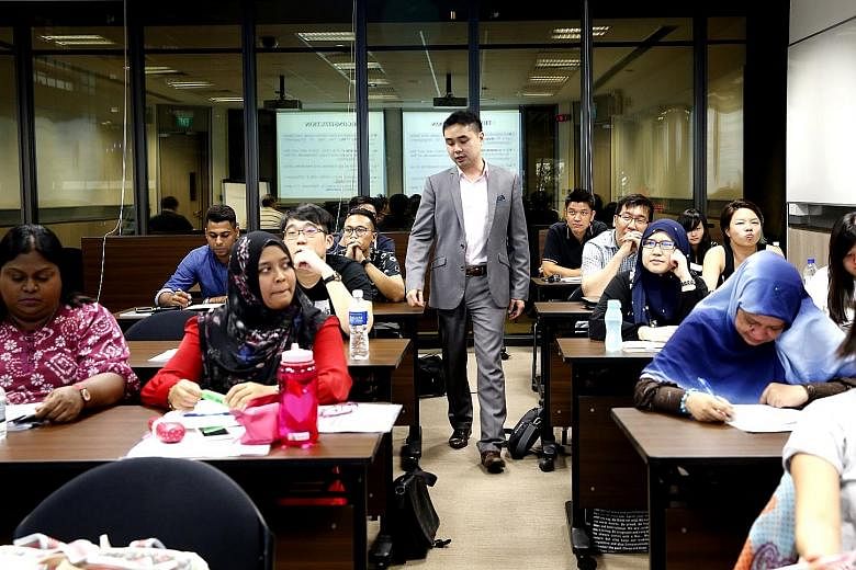 Lecturer Wong Yi conducting a law class at Temasek Polytechnic for part-time students.