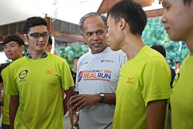 Mr Shanmugam with participants in the HomeTeamNS Real Run held on Sentosa yesterday. The minister said pilot trials related to SG Secure will begin next month in some constituencies, including his own Nee Soon GRC.
