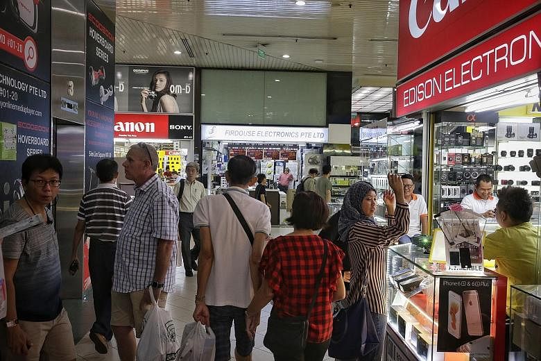 Shoppers at Sim Lim Square yesterday. The mall gained notoriety in 2014 for an incident involving a Vietnamese tourist. A shop owner there and four of his workers were later jailed for cheating.
