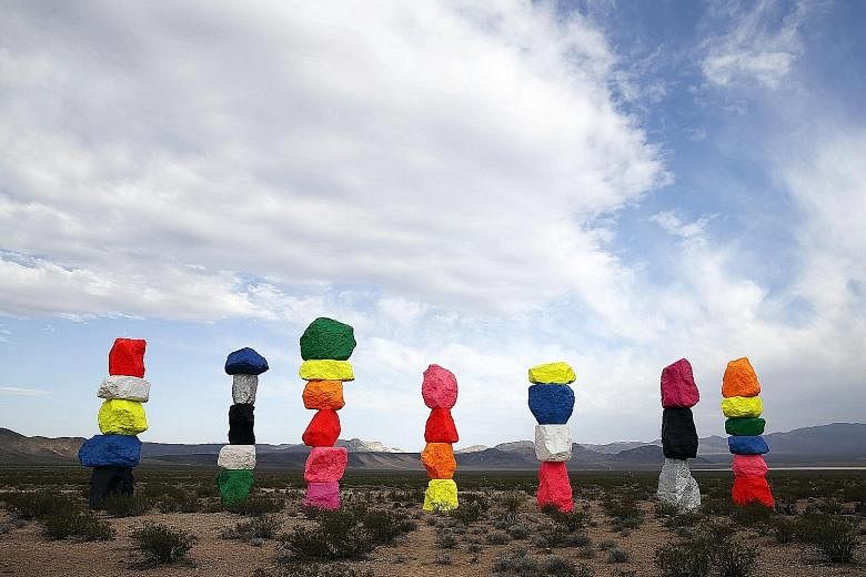 Swiss artist Ugo Rondinone (left) worked for more than five years to create Seven Magic Mountains (above), his largest public art installation.