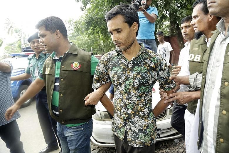 Shariful Islam Shihab under police escort in Dhaka yesterday. He allegedly owned one of the guns used in the murders of gay rights activists Xulhaz Mannan and Mahbub Tonoy last month, but he denies carrying out the killings.