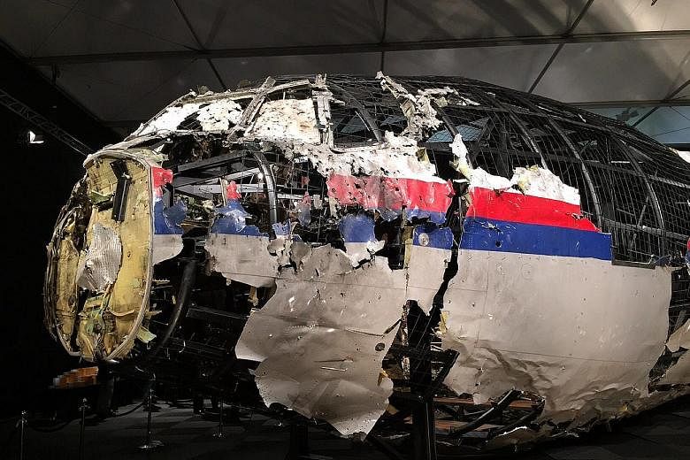 This photograph released yesterday shows the reconstructed front of the Malaysia Airlines plane that was downed by a missile over Ukraine, killing 298 people, at the Gilze-Rijen Air Force Base in the Netherlands in October last year. Parts of the coc