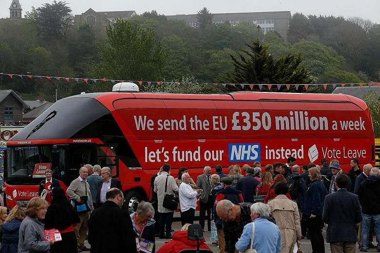 Supporters around the "Vote Leave" bus during a nationwide bus tour to campaign for a so-called Brexit in Britain last week. Four Wall Street banks told Reuters they have been drawing up contingency plans as part of their own risk planning and at reg