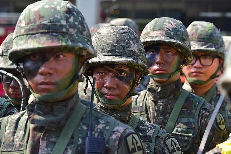 Soldiers taking part in an anti-terror drill in Seoul yesterday. Over 60 years after an armistice ended fighting in the Korean War, every South Korean man aged between 18 and 35 is required to perform two years of military service. The main rationale
