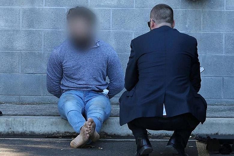 Tamim Khaja being arrested in Sydney yesterday. Australian police say he was trying to acquire a firearm and was also planning to leave the country to join the ISIS militant group.