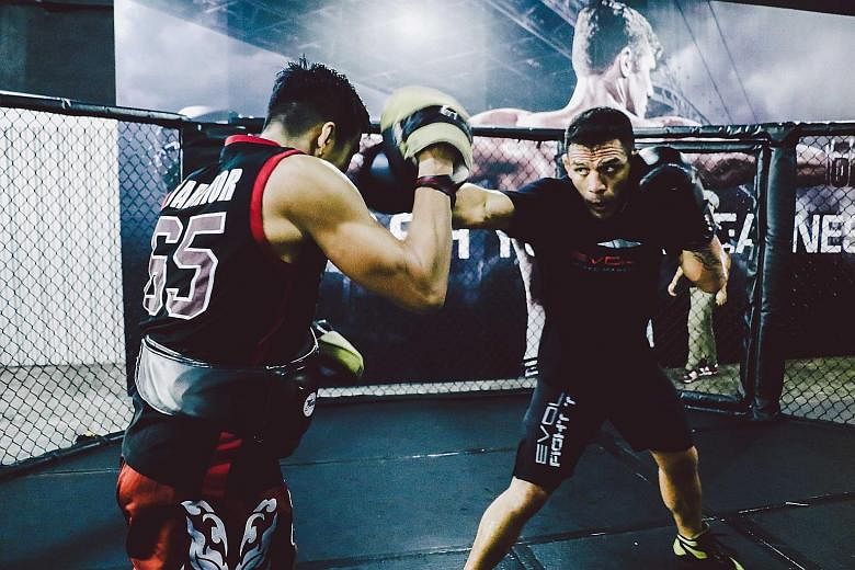 UFC lightweight champion Rafael dos Anjos (right) in training at Evolve MMA. The Brazilian will return to UFC action in July in a title bout with Eddie Alvarez.