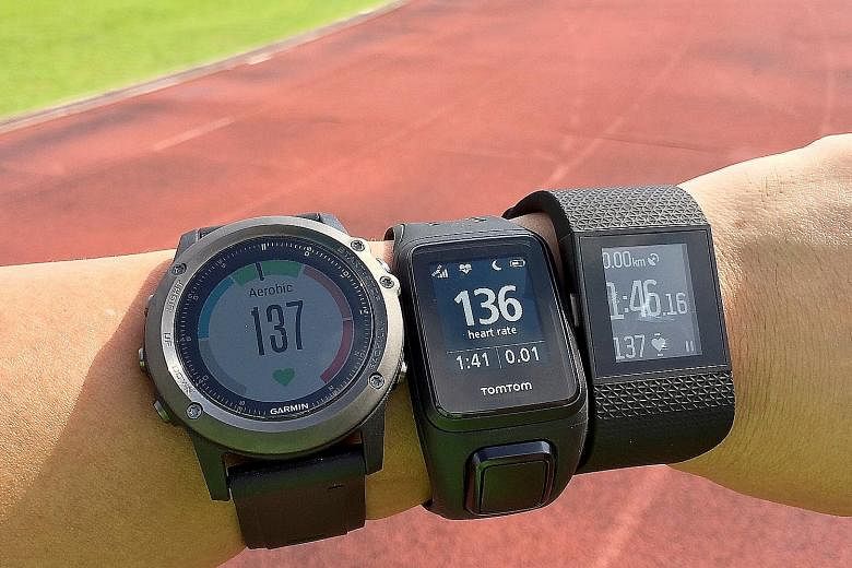 GPS running watches with built-in wrist-based heart rate monitors: (from left) the Garmin Fenix 3 HR, the TomTom Spark Cardio and the Fitbit Surge