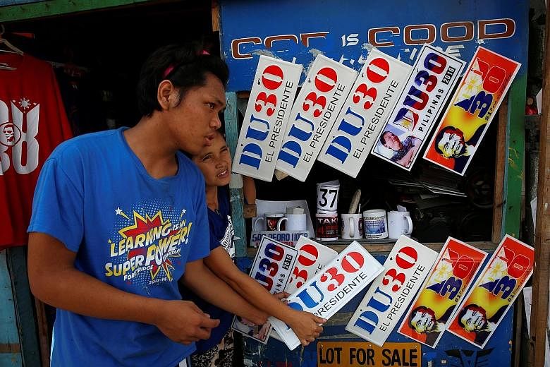 Vendors selling souvenir car bumper plates of Mr Duterte in Davao city last Wednesday. Mr Duterte has refused to travel to the capital, forcing political players seeking to jump on his bandwagon to head to Davao.