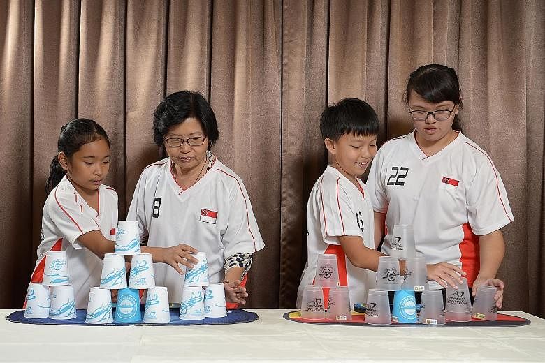 (From left) Shaina Nero Ruiz, Madam Phua Peck Ling, Edison Chew and Winnie Hiew are all champion cup stackers. Sport stacking, or cup stacking, is offered at various schools in Singapore as a co-curricular activity. It requires participants to stack 