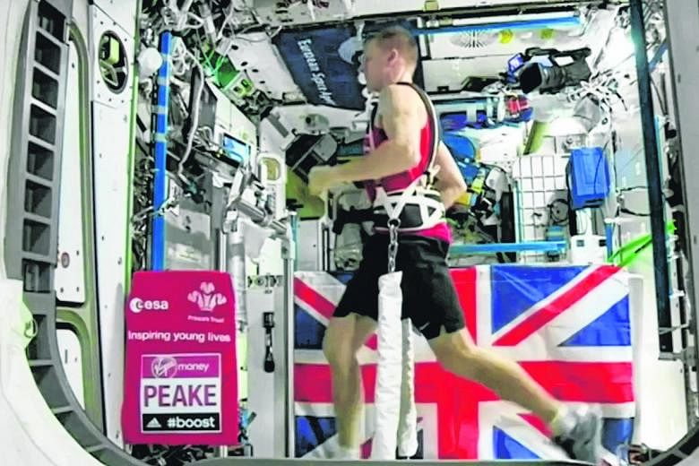 British astronaut Tim Peake (above) running on a treadmill aboard the International Space Station. He had used RunSocial, a software by Singapore fitness start-up Paofit, to help him train for this year's London Marathon.