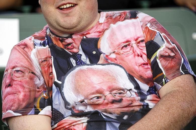 A supporter wearing a T-shirt with images of Mr Sanders before a campaign event in Carson, California, on Tuesday. Mr Sanders won the Oregon primary, while Mrs Clinton claimed Kentucky.