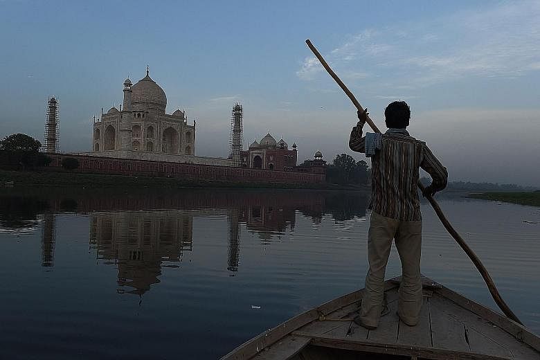 An Indian boatman on the Yamuna River behind the Taj Mahal on April 16. A petition over the pests at the monument was filed in the National Green Tribunal, an environmental court, last week.