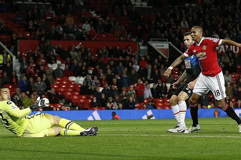 Manchester United substitute Ashley Young scoring his side's third goal against Bournemouth. Wayne Rooney and Marcus Rashford also netted, while defender Chris Smalling's own goal gave the visitors a late consolation.