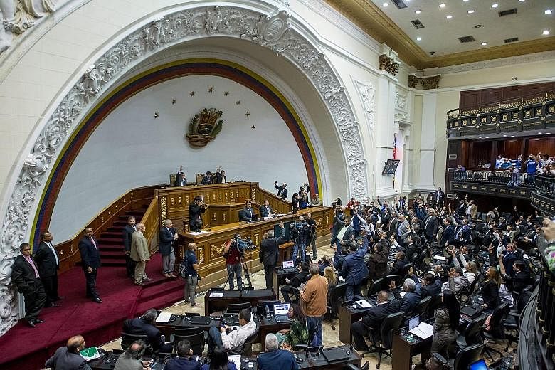 Legislators at the National Assembly in Caracas on Tuesday, when the opposition rejected Mr Maduro's emergency decree.