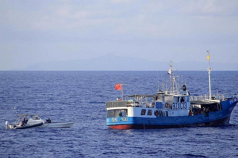 Philippine Coast Guard officers checking a Chinese vessel in the northern Balintang Channel this week. Manila has lodged a case with a UN court challenging China's claims in the South China Sea.