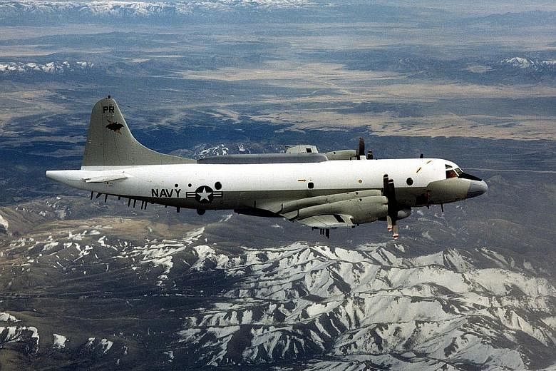 An undated picture provided by the US Department of Defence shows a US Navy EP-3 flying over an unknown location. Two Chinese fighter jets flew within 15m of a US EP-3 plane on Tuesday.