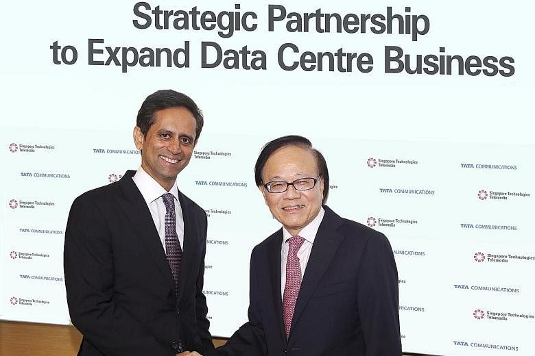 ST Telemedia's Mr Sio (far right) and Tata Communications' Mr Kumar. Under the deal, STT GDC will acquire a 74 per cent majority stake in Tata Communications' data centre business in India and Singapore.