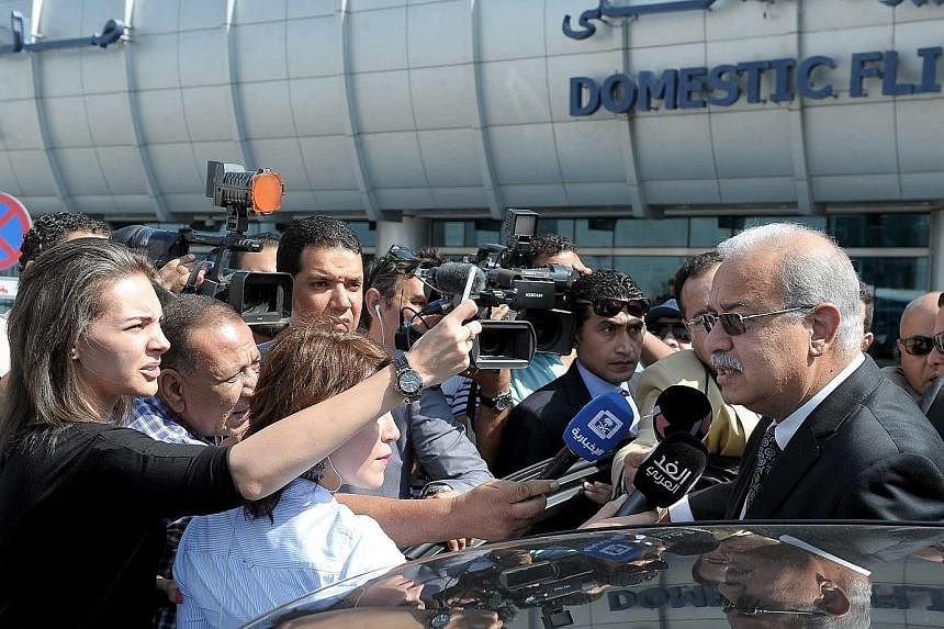 Egyptian Prime Minister Sherif Ismail (right) speaking to reporters after arriving at Cairo International Airport to follow up on the incident involving EgyptAir Flight MS804 yesterday. A soldier patrolling near the EgyptAir check-in desk at Charles 