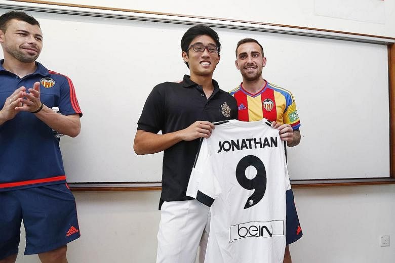 Paco Alcacer presenting RI striker Jonathan Chua with a personalised jersey. The Valencia captain and five other former and current players paid him an unannounced class visit. Alcacer stressed that in football "you have to try and do the right thing