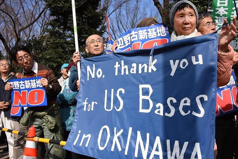 Protesters at a rally in front of the National Diet in Tokyo in February this year to raise objections to plans for a new US military base on Okinawa. Crimes by American personnel are a potent rallying point for Okinawans and others in Japan who oppo