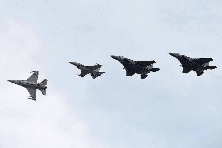 RSAF F-15 and F-16 fighter jets demonstrating their abilities during an aerial display at the open house yesterday. The air force's public outreach event made a return after a five-year hiatus.