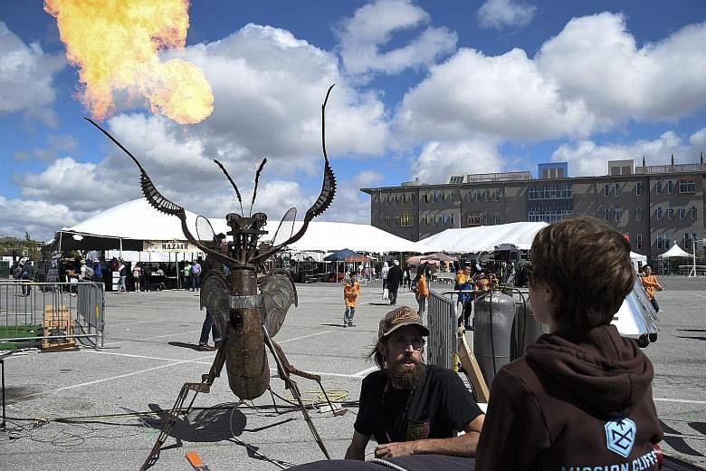 San Francisco sculptor-artist Todd Cox with his Metal Praying Mantis during the Maker Faire Bay Area 2016 festival at the San Mateo Event Centre in California yesterday. The Maker Faire is a family-friendly, hands-on festival that draws together tech
