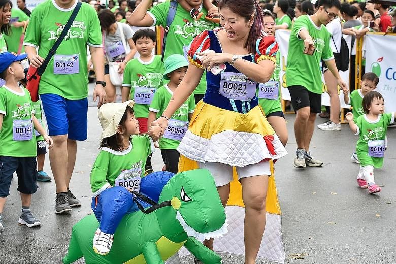 Three-year-old Merrily Tan "rode" her way on an inflated dinosaur to win the Fancy Dress Family Fun category at the Cold Storage Kids Run yesterday with her mother, Joycelyn Pang, 39, who came dressed as Snow White. The mother-daughter pair were amon