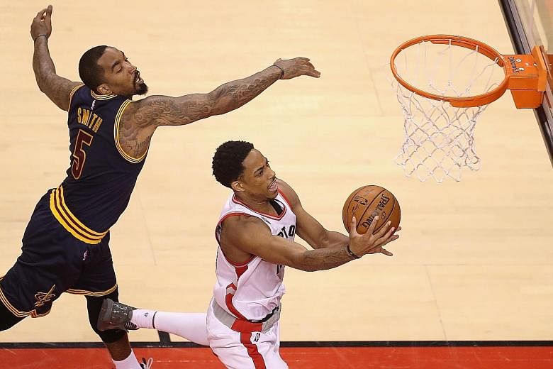 Toronto's DeMar DeRozan, who top-scored with 32 points, getting in a shot despite the close attention of Cleveland's J.R. Smith in Game 3 of the Eastern Conference Finals. The Cavs' 84-99 loss means they failed to equal the LA Lakers' mark of 11 stra