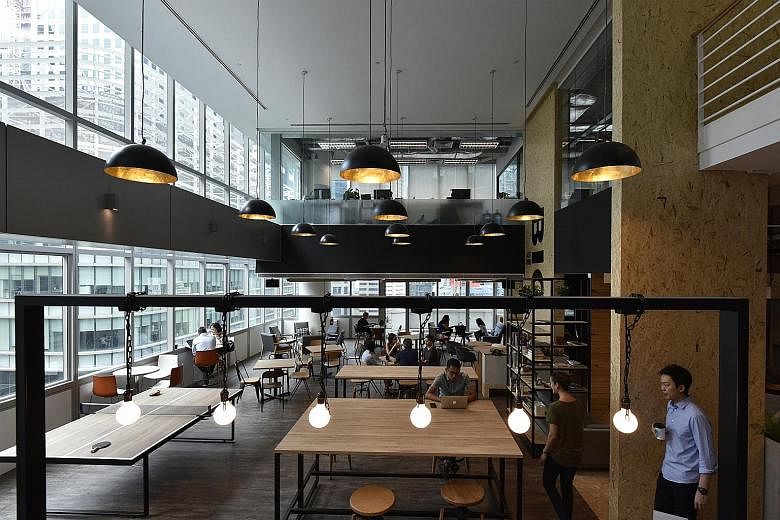 Co-working spaces in Singapore are increasingly popular with foreign start-ups looking to expand here. JustCo at 120 Robinson Road has an open space area where tenants can interact with one another..