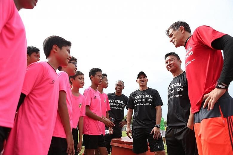 (From right) ActiveSG Football Academy principal Aleksandar Duric and head coaches Richard Bok, Robin Chitrakar and Hairil Amin talking to players from Juying Secondary. Duric says the programme aims to teach not only footballing tactics but also lif