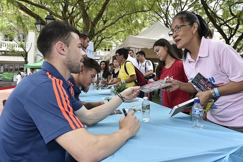 Valencia players signing autographs at UN Women's campaign for foreign domestic workers at Chijmes. This was the Spanish club's final stop during their five-day visit to Singapore.