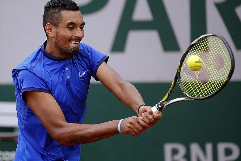 Nick Kyrgios making a backhand return to Marco Cecchinato. He was warned by the umpire for shouting at a ball boy who was slow in handing him his towel and later ranted that top stars are treated differently.