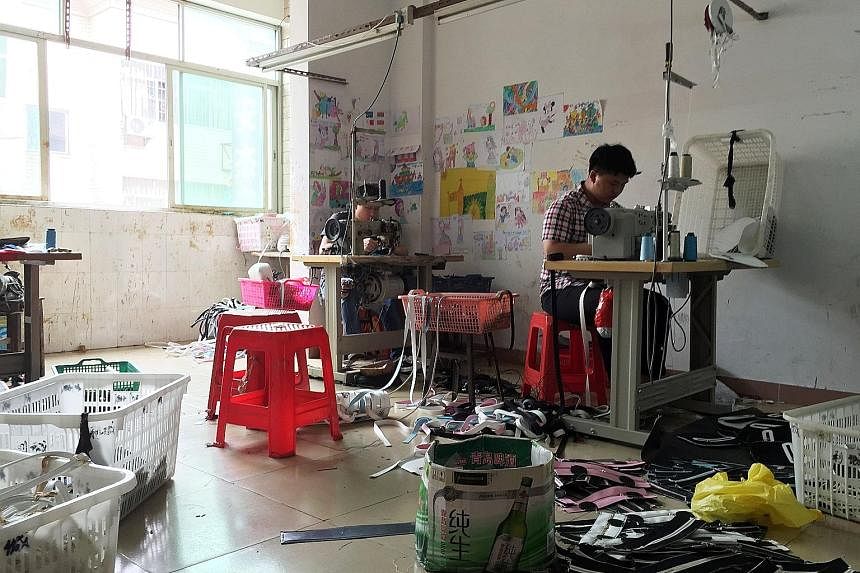 Workers looking for jobs (above) in Shiling, Guangdong province. The town is China's bag capital, where small companies producing bags (left) hire workers by the day instead of on regular contracts to minimise staff costs.