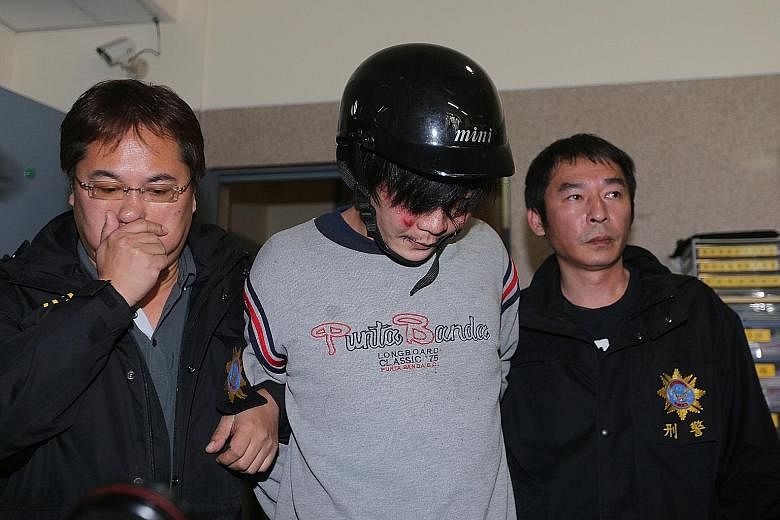 Wang (centre) is accused of beheading a four-year-old girl in March, in the presence of her mother, an act described as "extremely cold-blooded" by Taiwanese prosecutors.