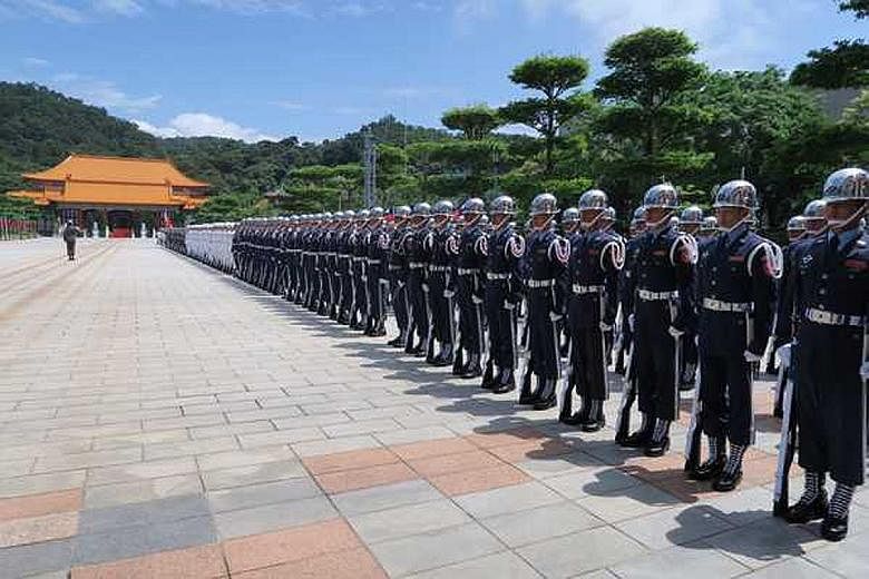 Honour guards lining up outside the National Revolutionary Martyrs' Shrine in Taipei yesterday as President Tsai visited the memorial.