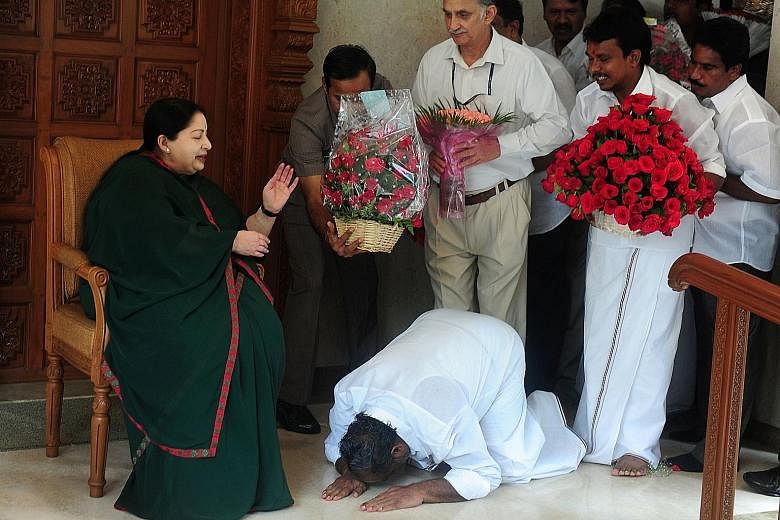 An AIADMK supporter bowing at the feet of Ms Jayalalithaa at her residence in Chennai last Thursday.