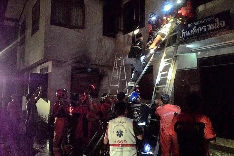 Firefighters and rescue workers saving an injured pupil after a fire broke out late on Sunday in the dormitory of a boarding school in Thailand's northern Chiang Rai province.