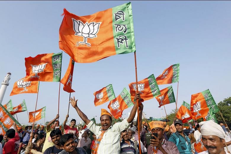 BJP supporters waving party flags while waiting for Mr Modi to address an election rally in Kolkata last month. The BJP has no ready response to the domination of powerful leaders like Ms Mamata Banerjee in West Bengal and Ms J. Jayalalithaa in Tamil Nadu