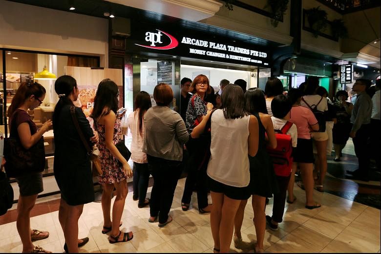 The queue at a moneychanger in Raffles Place when the ringgit hit a low last year. 