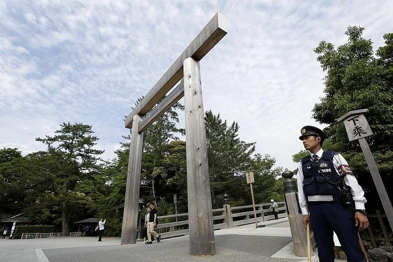 A policeman patrolling a torii gate on the Ujibashi Bridge connecting to the Inner Shrine of Ise Grand Shrine yesterday. Japan will deploy up to 23,000 officers to provide security for the G-7 summit in Mie, and in the neighbouring prefecture of Aich
