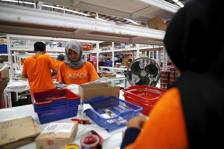 An employee at online retailer Lazada filling an order at a warehouse in Jakarta, Indonesia. South-east Asia's Internet user base of 260 million is expected to grow to 480 million by 2020, says Google.
