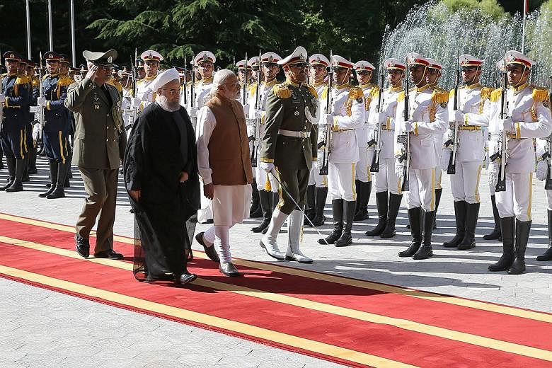 Mr Modi (right) inspecting a guard of honour with Iranian President Hassan Rouhani during a visit to Teheran on Monday.